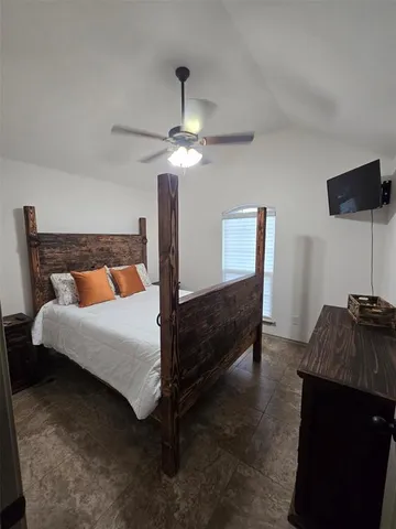 a view of a hallway with workspace and a window