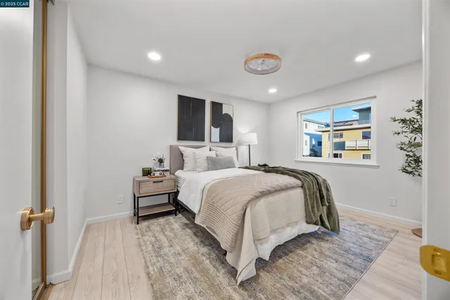 a bedroom with a bed and a large window