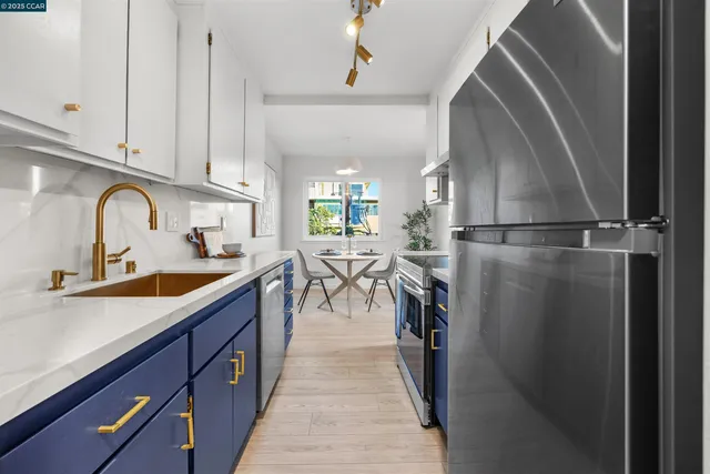 a kitchen with stainless steel appliances a sink and cabinets