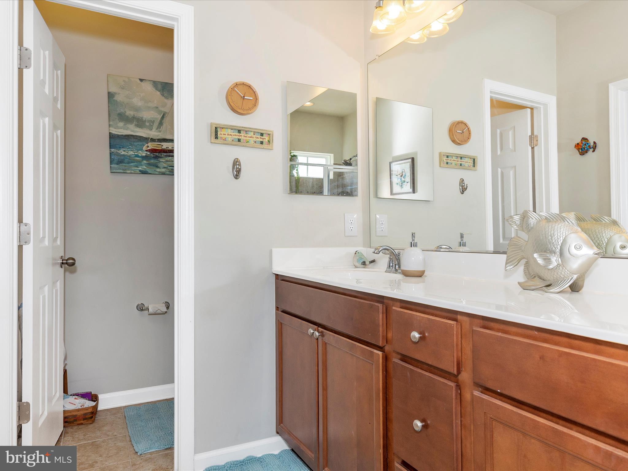 5918 Jefferson Commons Way Frederick, MD 21703 - Photo 29 of 69 a bathroom with a granite countertop sink and a mirror