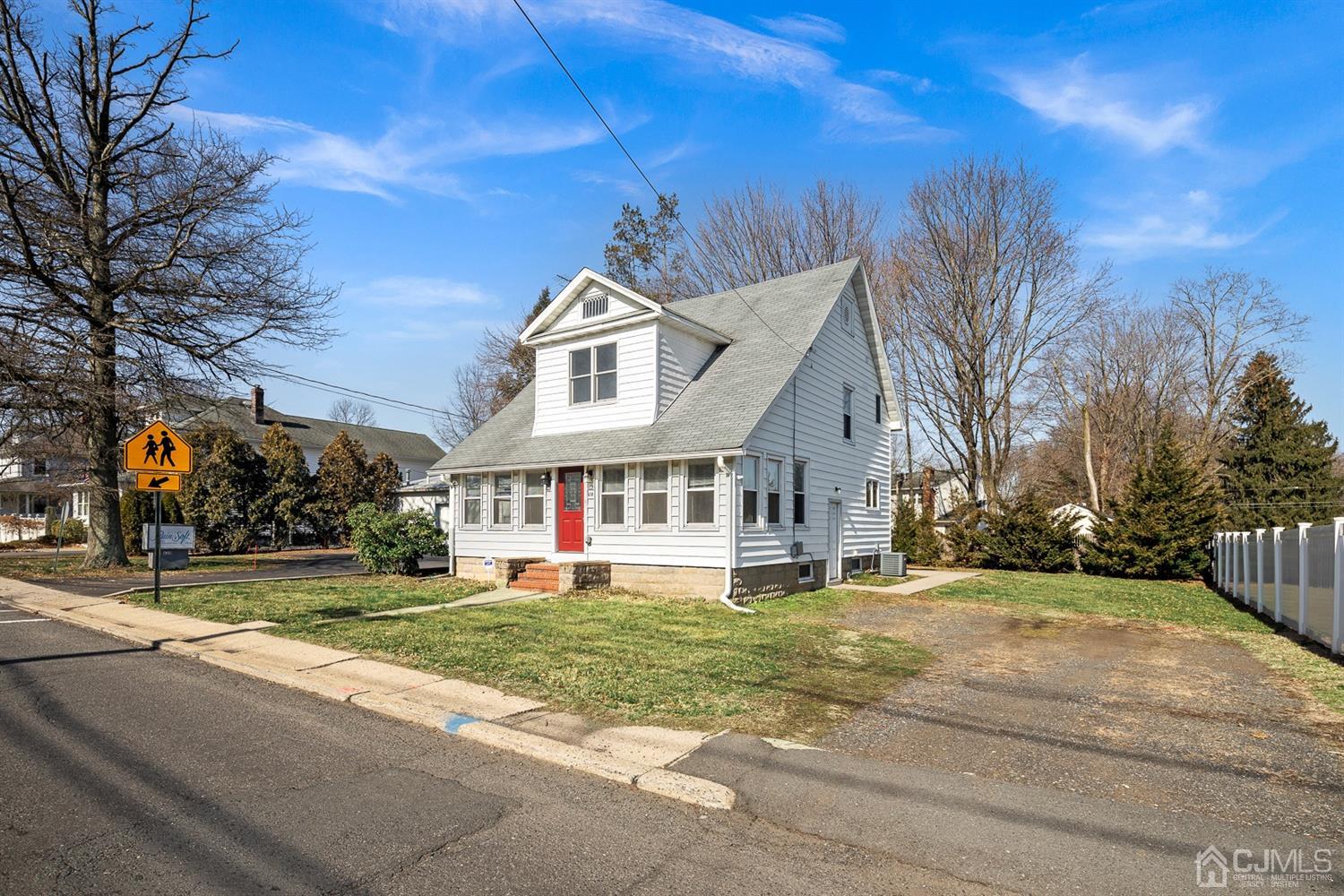 618 Ridge Road Monmouth Junction, NJ 08852 - Photo 1 of 18 a view of a white house with a big yard and large trees