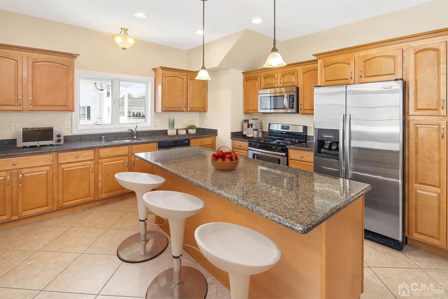 618 Ridge Road Monmouth Junction, NJ 08852 - Photo 2 of 18 a kitchen with stainless steel appliances granite countertop a sink a stove a dining table and chairs