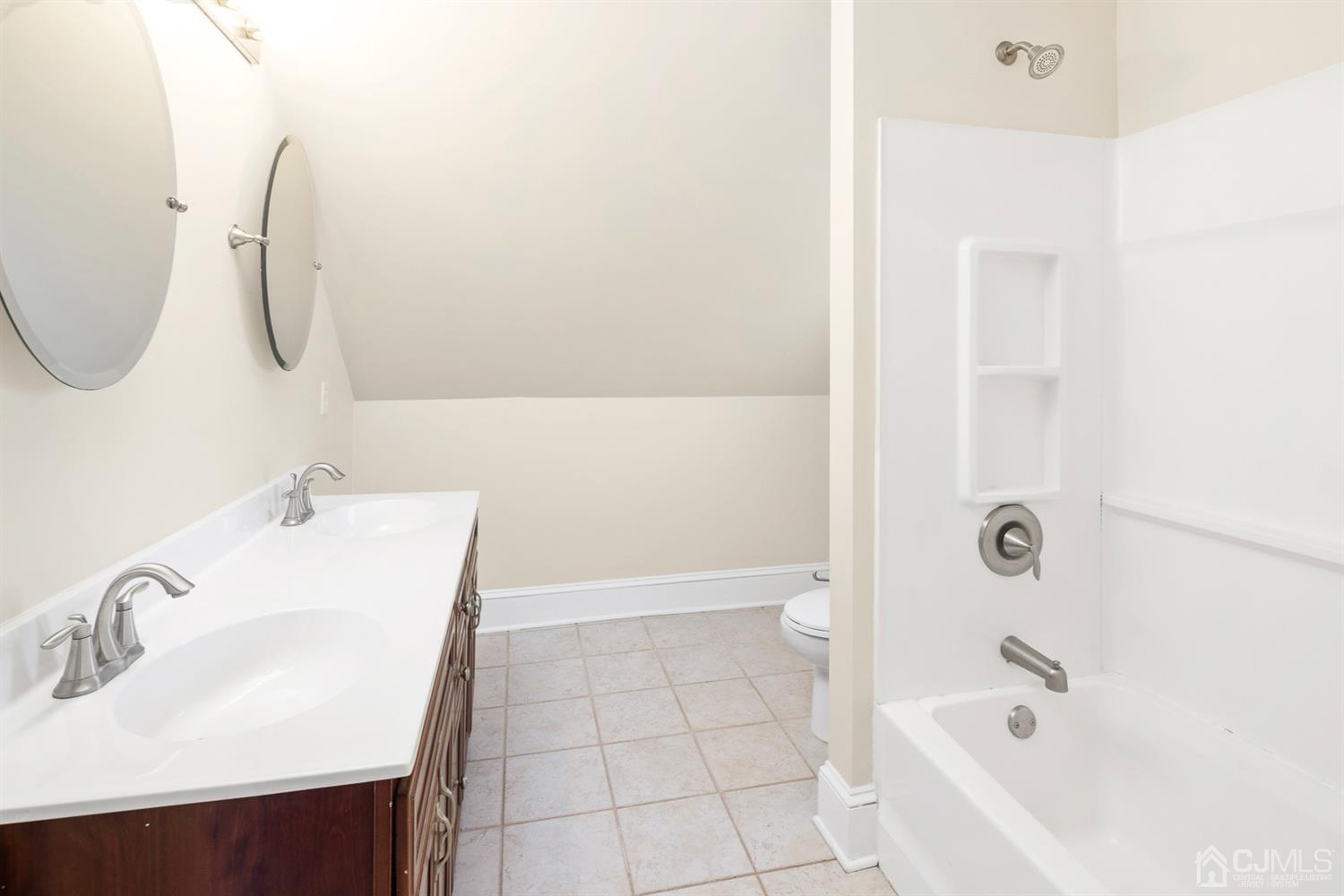 618 Ridge Road Monmouth Junction, NJ 08852 - Photo 13 of 18 a bathroom with a sink a bathtub and a shower
