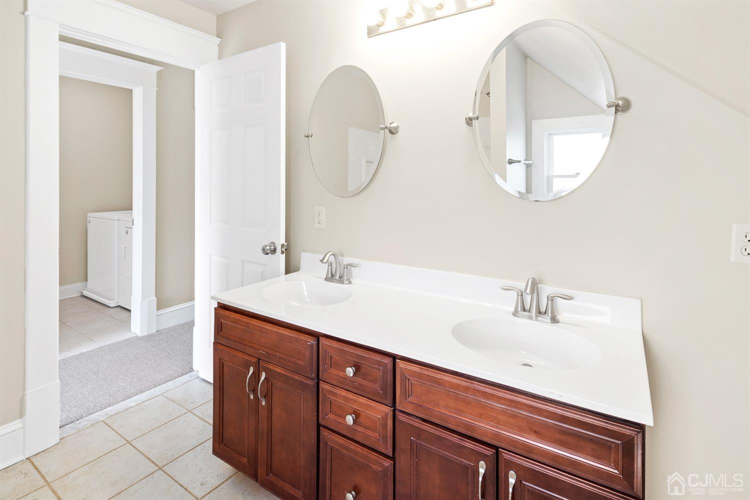 618 Ridge Road Monmouth Junction, NJ 08852 - Photo 14 of 18 a bathroom with a double vanity sink and a mirror