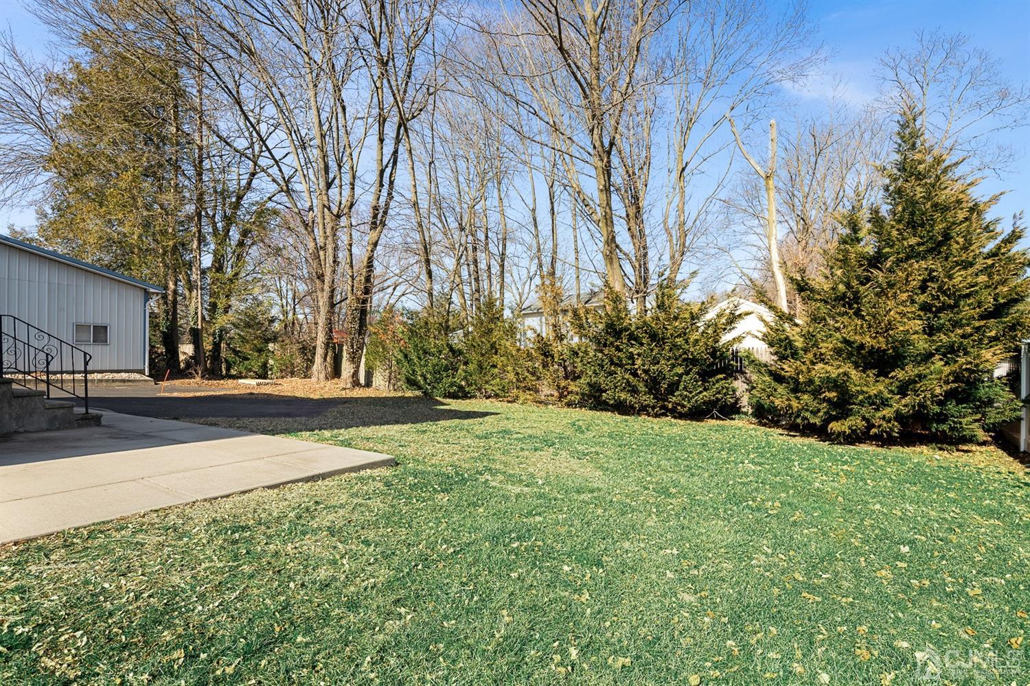 618 Ridge Road Monmouth Junction, NJ 08852 - Photo 17 of 18 a view of a yard with plants and trees