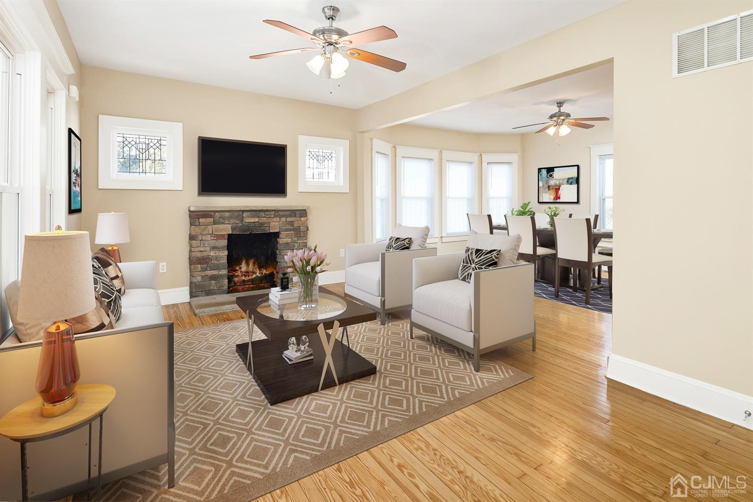 618 Ridge Road Monmouth Junction, NJ 08852 - Photo 6 of 18 a living room with furniture fireplace and a flat screen tv