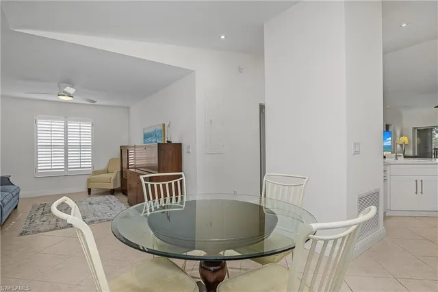 a kitchen with white cabinets and sink