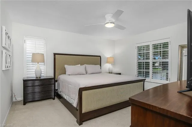 a bedroom with a bed and a television