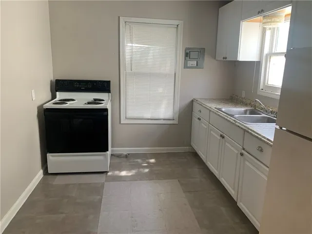 a kitchen with a stove and a window