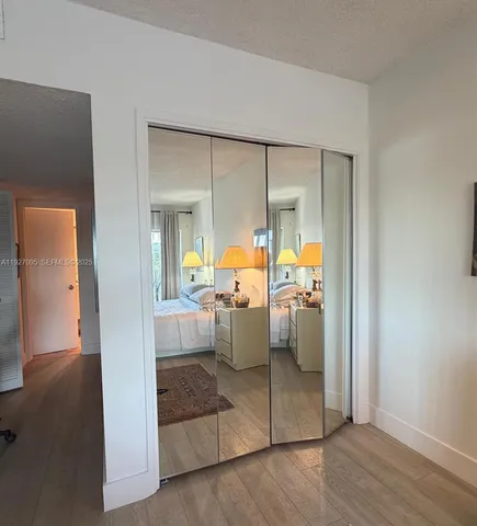 a view of a hallway with closet and a window