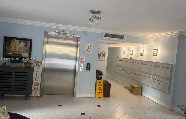 a room with a baby crib furniture and a chandelier