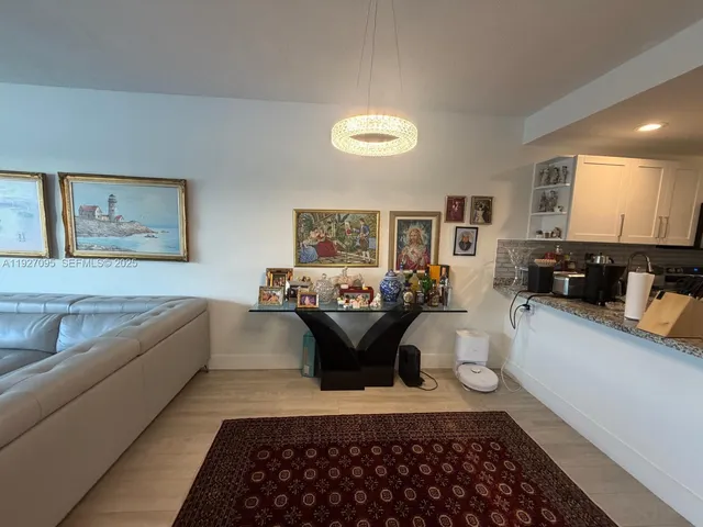 a view of a living room and bathroom with bathtub