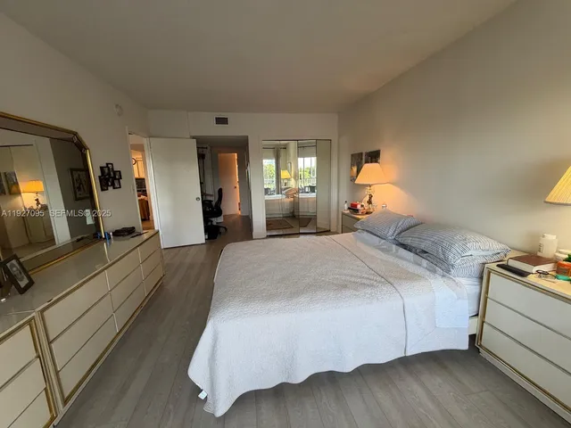 a bed room with a bed and a large mirror