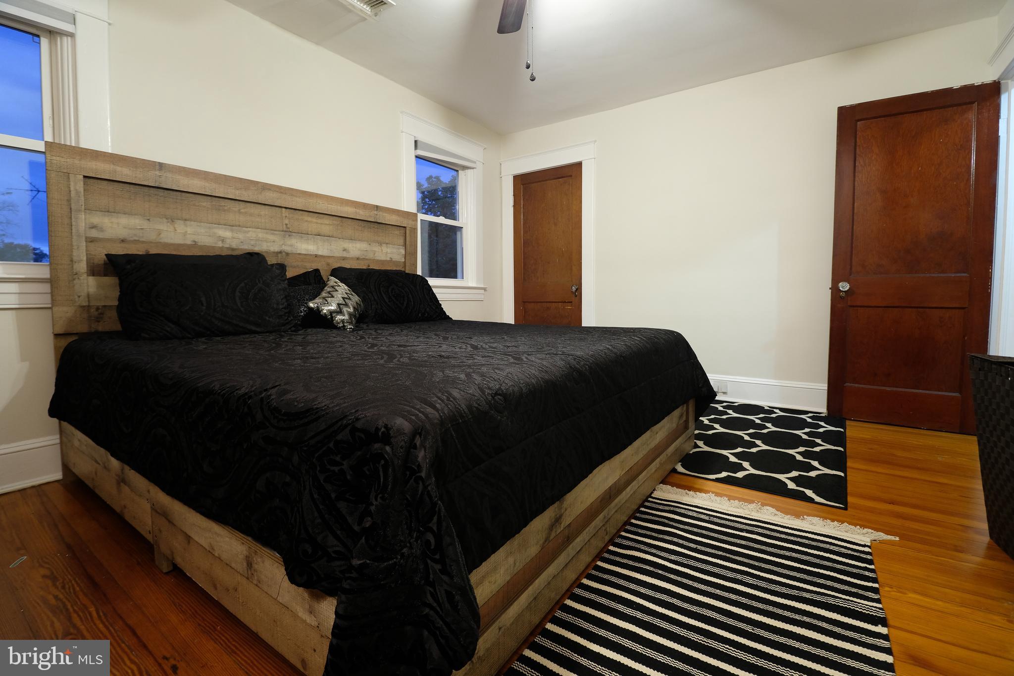 905 Woodsdale Road Catonsville, MD 21228 - Photo 12 of 23 a bedroom with a bed and wooden floor