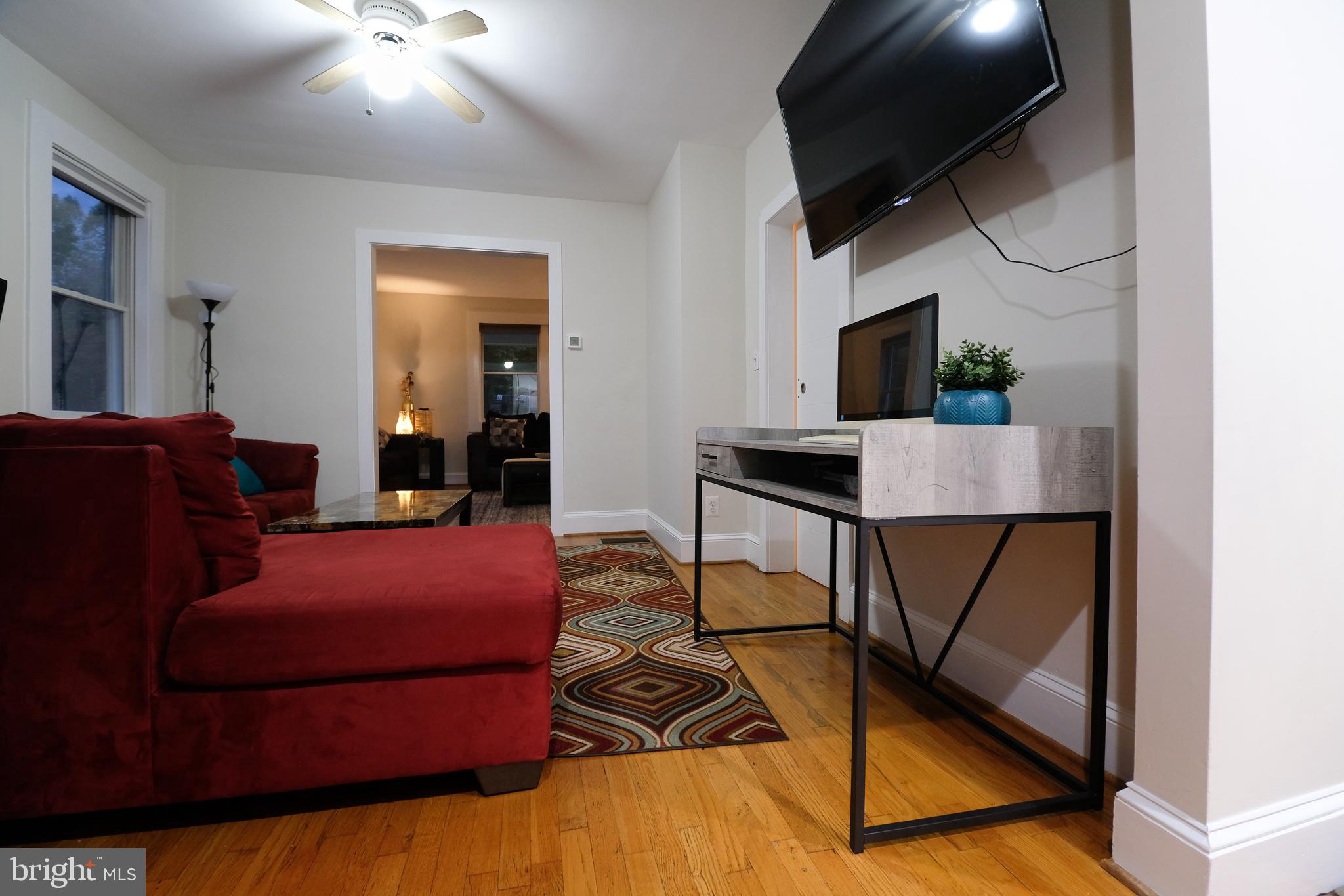 905 Woodsdale Road Catonsville, MD 21228 - Photo 6 of 23 a reading room with furniture and a flat screen tv