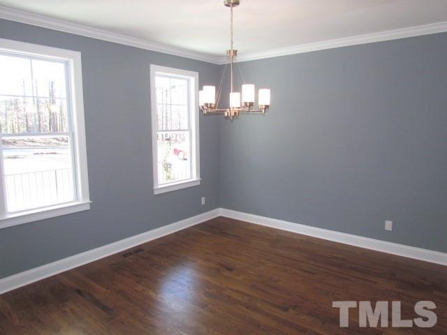 1628 Forest Road Wake Forest, NC 27587 - Photo 3 of 25 Stunning dining room w/ site finished hardwood floors, crown moulding, chandelier and custom paint color.