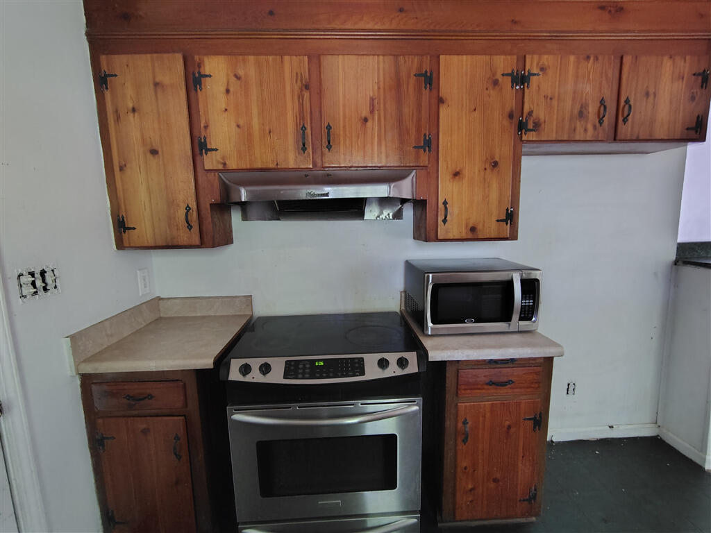 5031 Showalter Road Northwest Roanoke, VA 24017 - Photo 15 of 21 a kitchen with a stove and a microwave