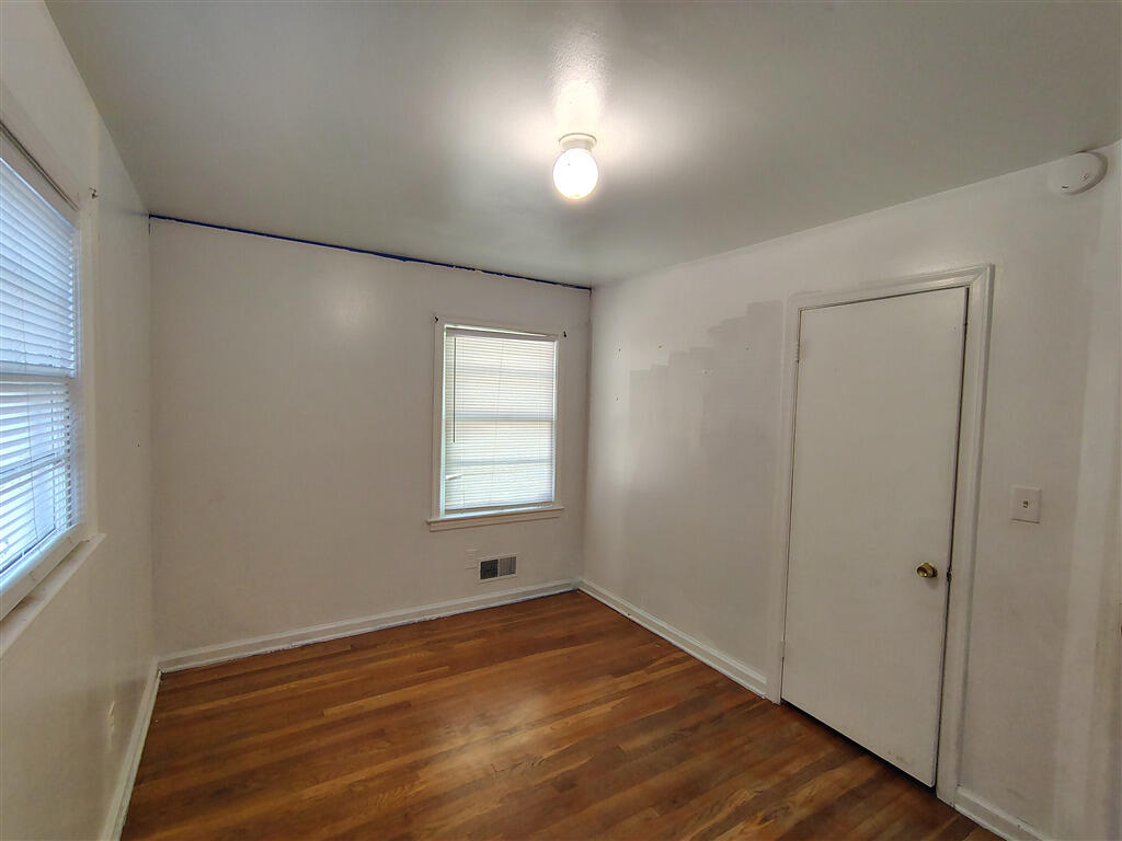 5031 Showalter Road Northwest Roanoke, VA 24017 - Photo 7 of 21 an empty room with wooden floor and windows