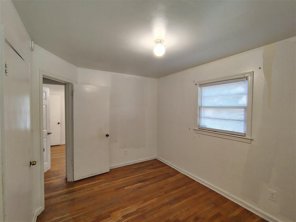 5031 Showalter Road Northwest Roanoke, VA 24017 - Photo 8 of 21 a view of an empty room with wooden floor and a window