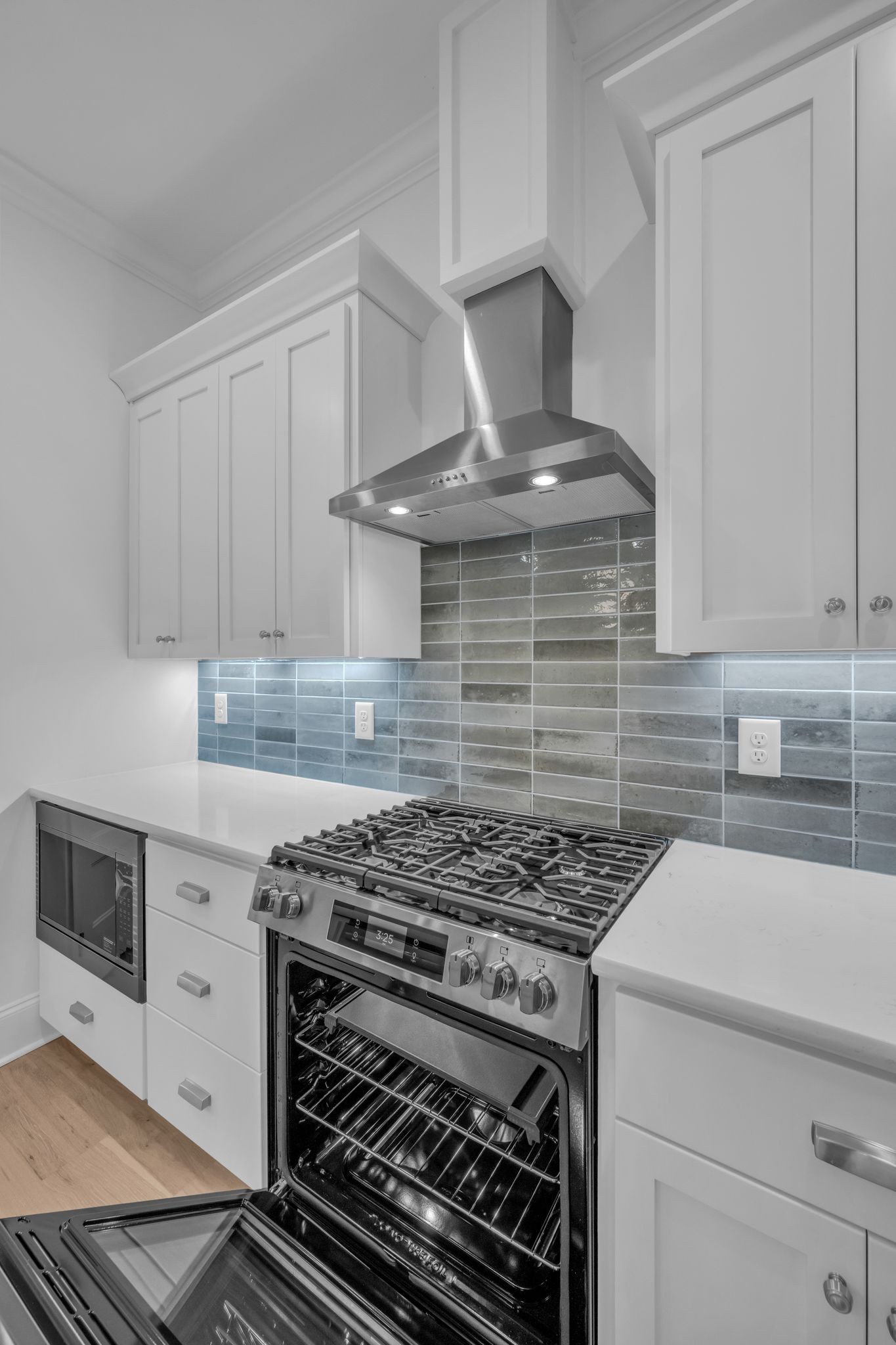 7137 Frances Street Fairview, TN 37062 - Photo 26 of 64 a kitchen with a stove and white cabinets