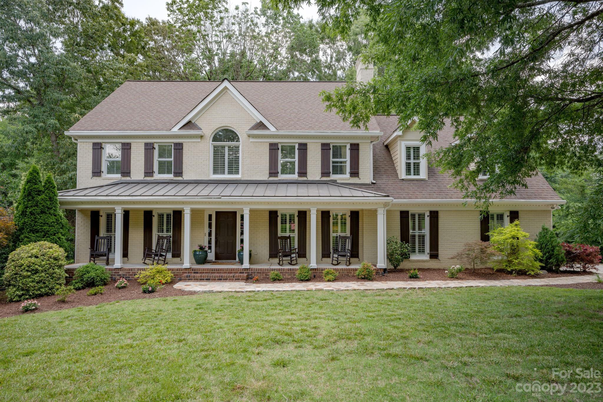 170 Kimberly Road Davidson, NC 28036 - Photo 3 of 37 a front view of a house with yard porch and green space
