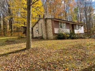53 Miller Road Mill Run, PA 15464 - Photo 2 of 18 a house view with backyard space