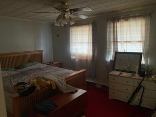 53 Miller Road Mill Run, PA 15464 - Photo 6 of 18 a bedroom with a bed and a flat tv screen on the dresser