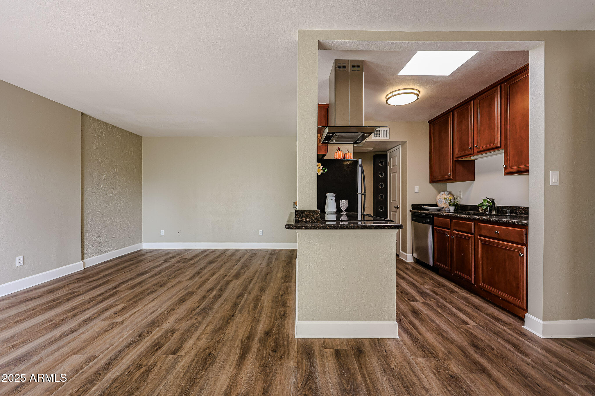 4419 North 27th Street, Unit 22 Phoenix, AZ 85016 - Photo 16 of 46 a kitchen with wooden floors and cabinets