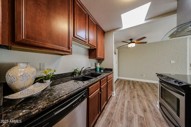a kitchen with granite countertop a stove and a sink