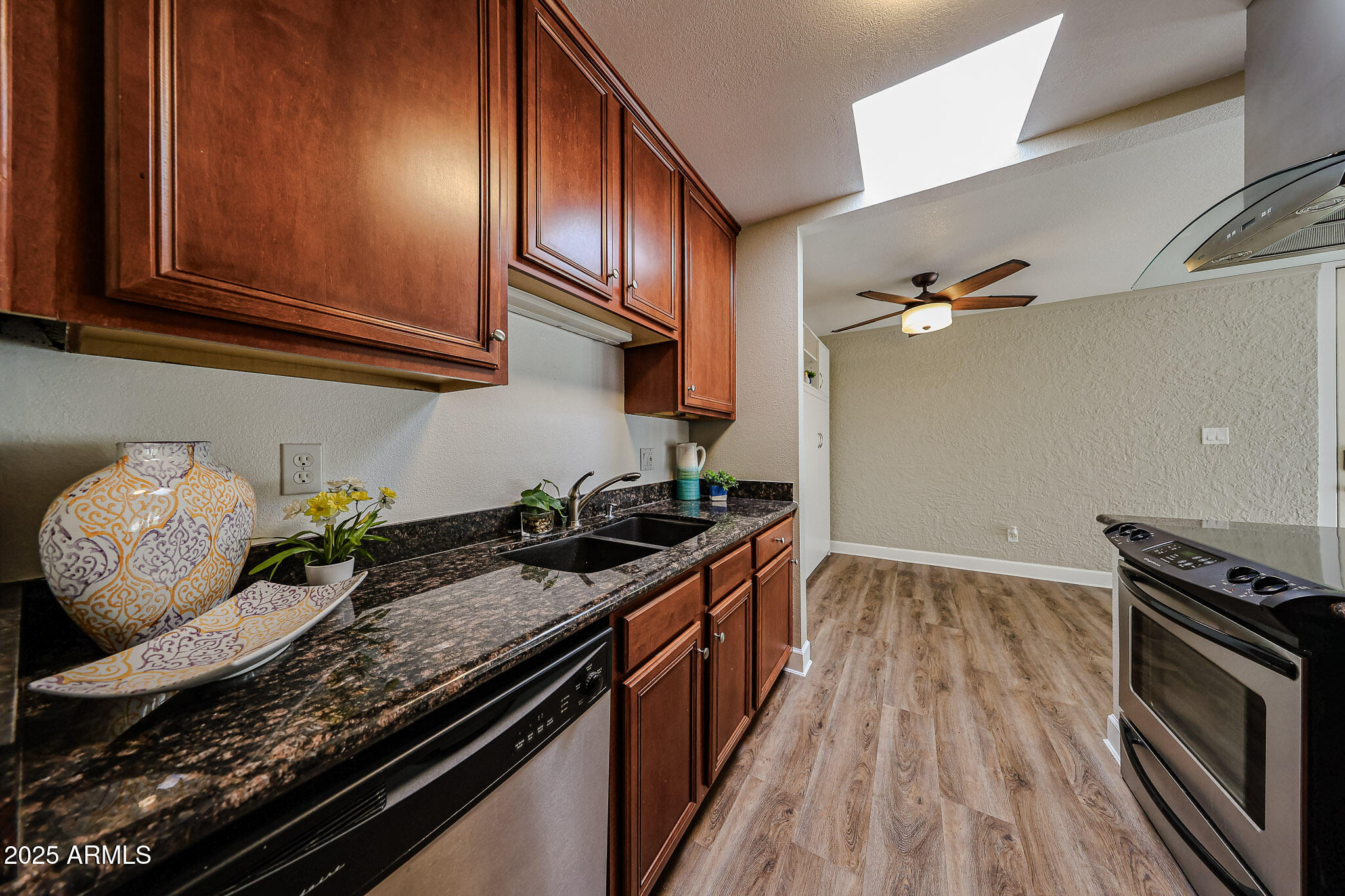 4419 North 27th Street, Unit 22 Phoenix, AZ 85016 - Photo 5 of 46 a kitchen with granite countertop a stove and a sink