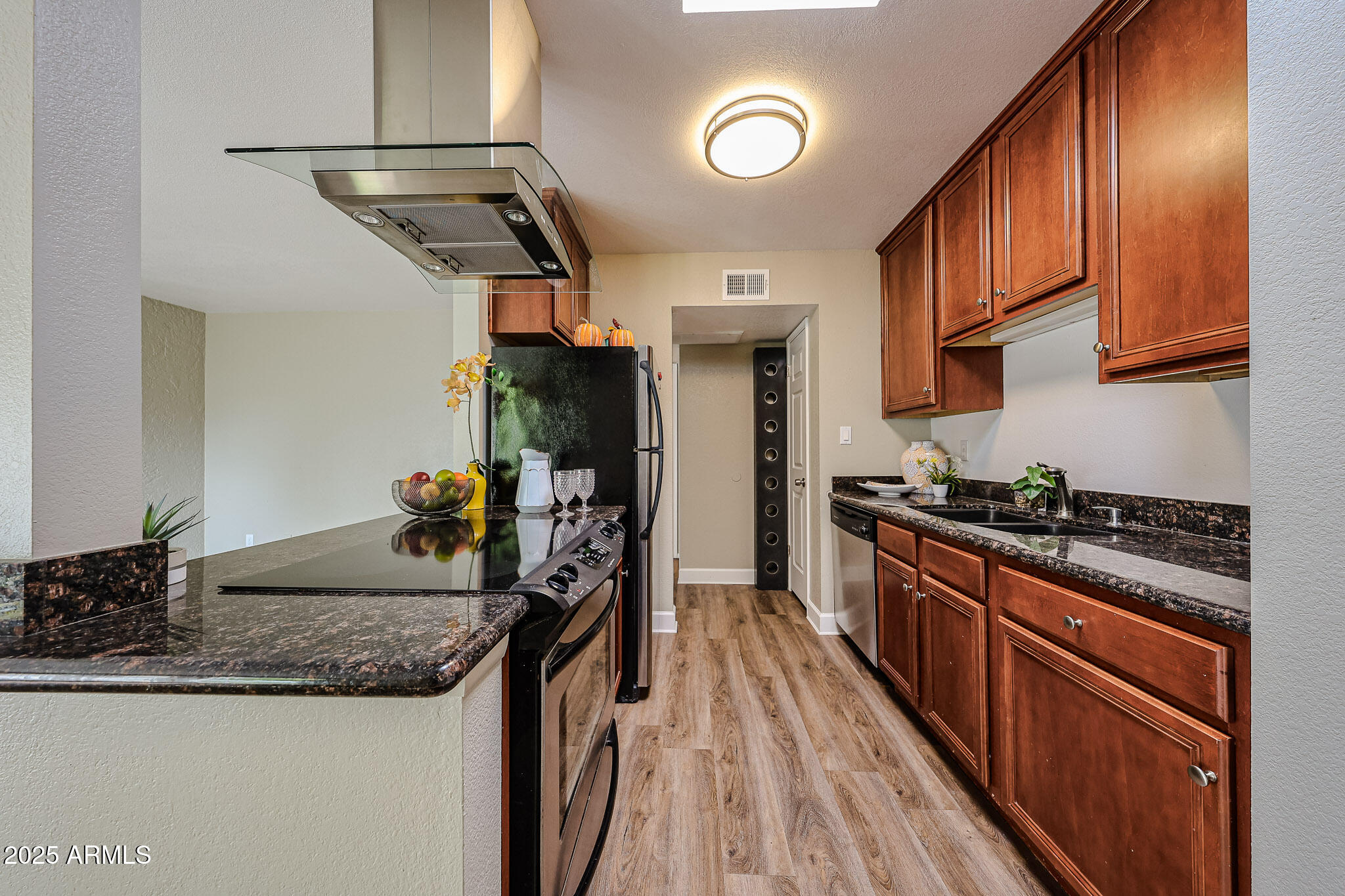 4419 North 27th Street, Unit 22 Phoenix, AZ 85016 - Photo 7 of 46 a kitchen with granite countertop a sink a stove top oven and cabinetry