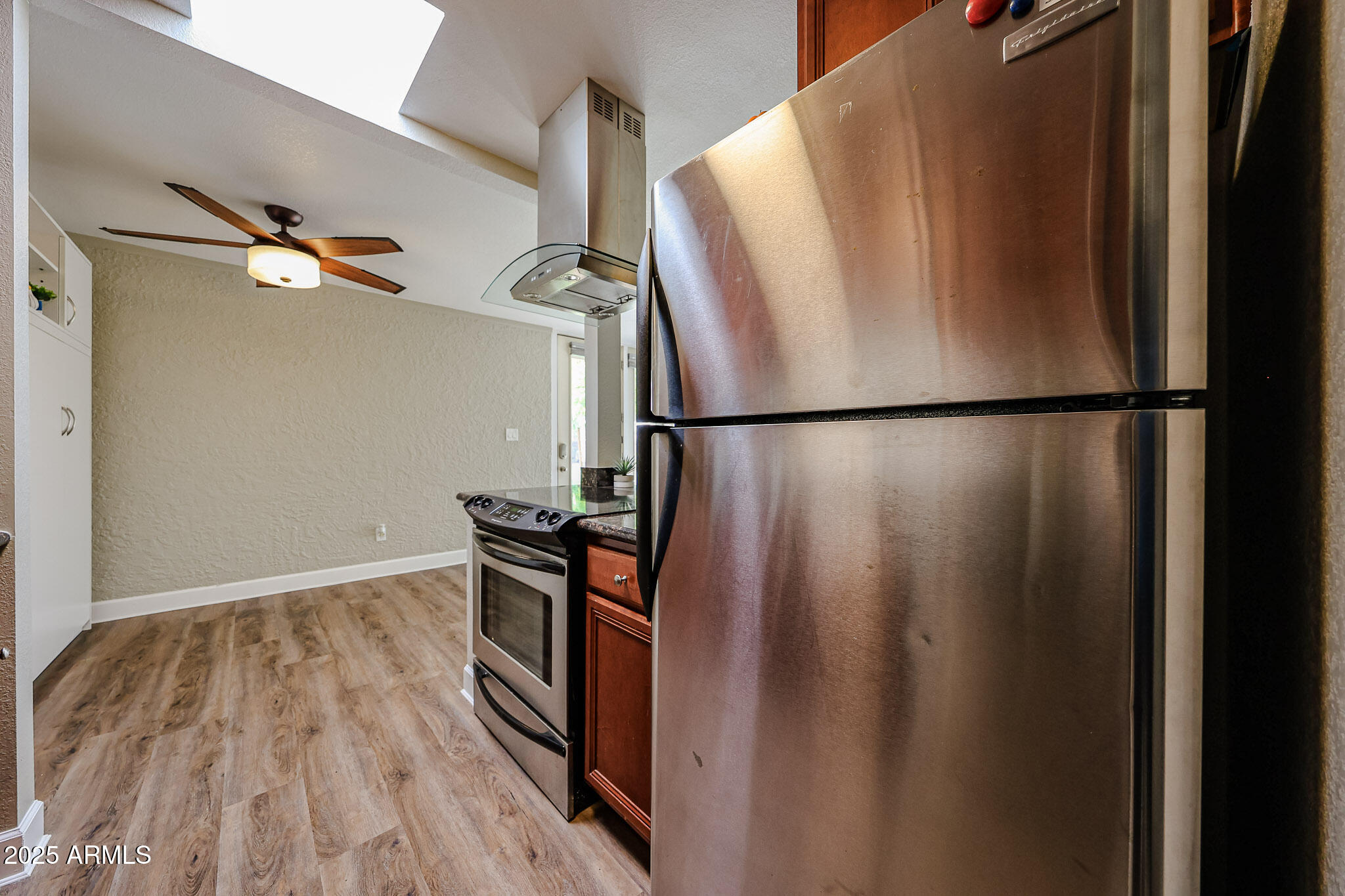 4419 North 27th Street, Unit 22 Phoenix, AZ 85016 - Photo 10 of 46 a view of a refrigerator in kitchen and wooden floor