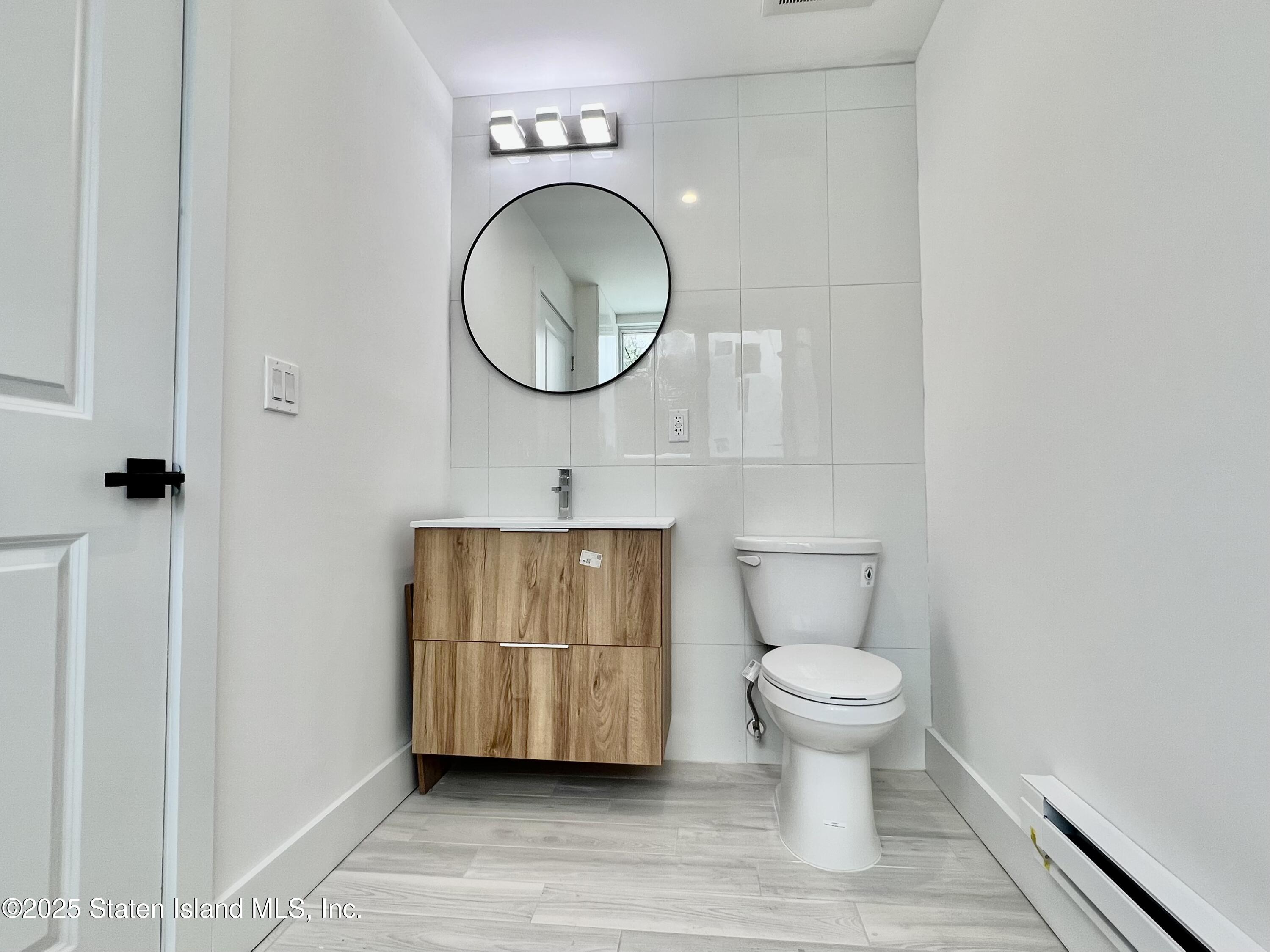 3865 Amboy Road, Unit 4A Staten Island, NY 10308 - Photo 11 of 18 a bathroom with a toilet and a mirror