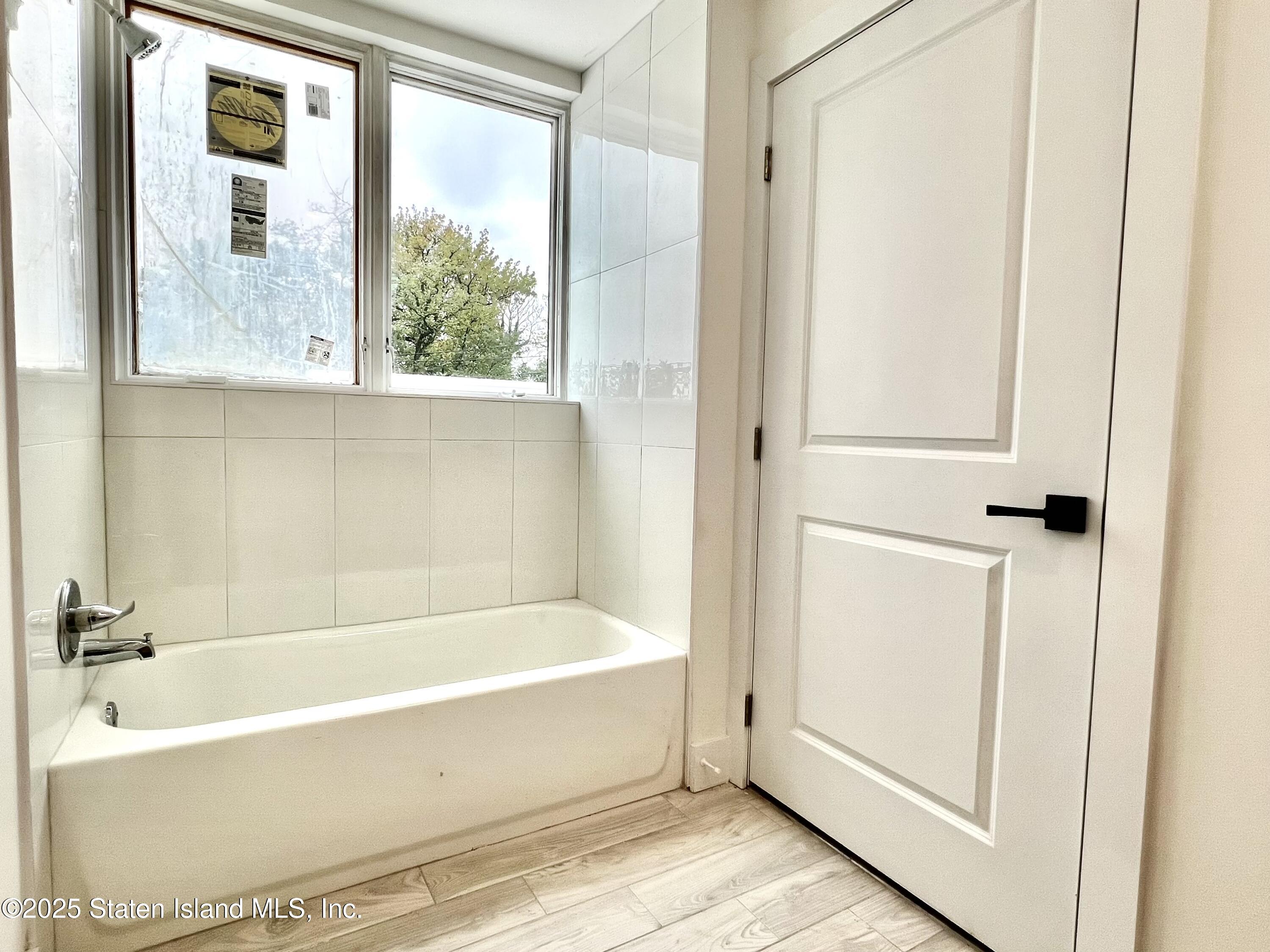 3865 Amboy Road, Unit 4A Staten Island, NY 10308 - Photo 12 of 18 a bathroom with bathtub and window