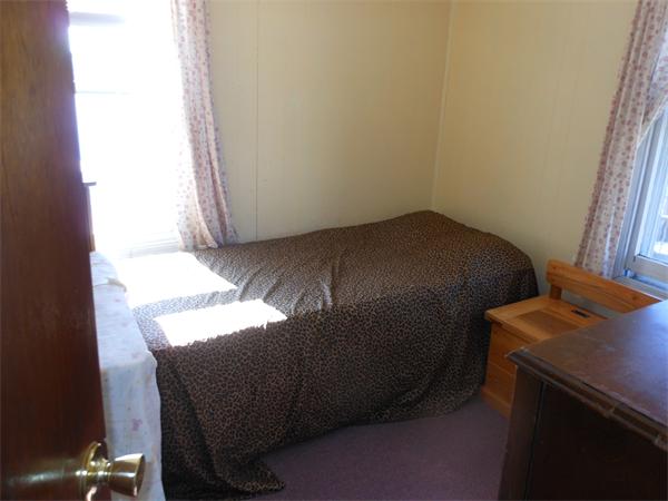 52 Pequot Point Road Westfield, MA 01085 - Photo 13 of 17 a bed sitting in a bedroom next to a window