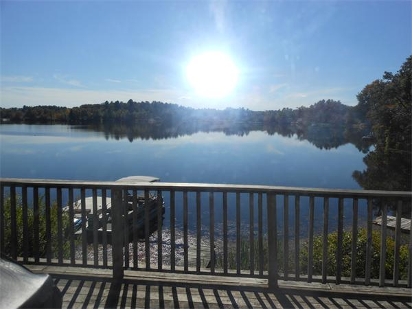 52 Pequot Point Road Westfield, MA 01085 - Photo 17 of 17 a balcony with wooden floor and lake view