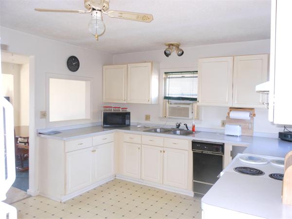 52 Pequot Point Road Westfield, MA 01085 - Photo 6 of 17 a kitchen with a sink window and cabinets