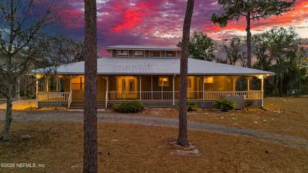 a view of a house with backyard porch and sitting area