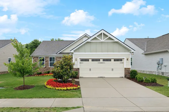 a front view of a house with a garden