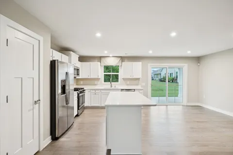 a kitchen with stainless steel appliances a refrigerator and a stove top oven