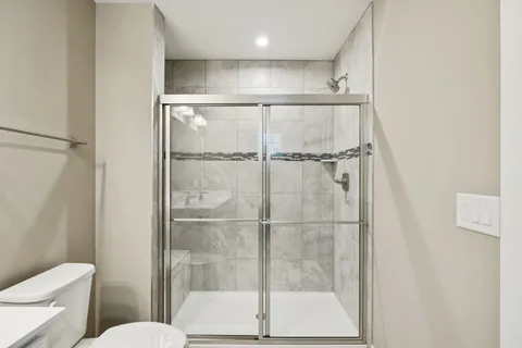 a bathroom with a shower and a toilet