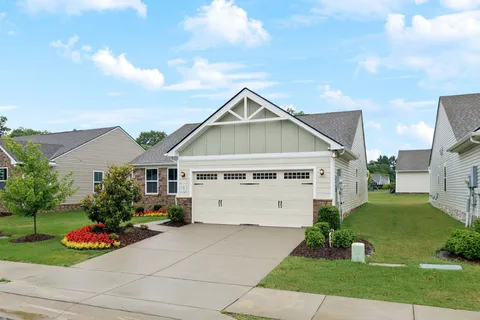 a front view of house with yard and green space