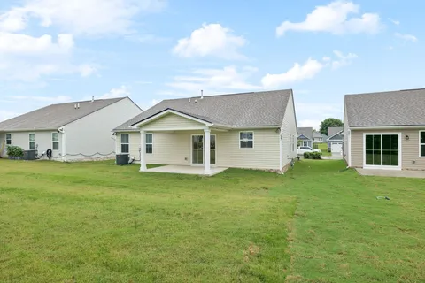 a front view of house with yard and green space