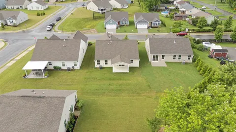 an aerial view of a residential apartment building with a yard