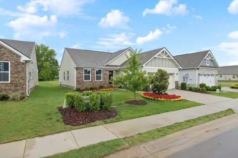 a front view of a house with a garden and pathway