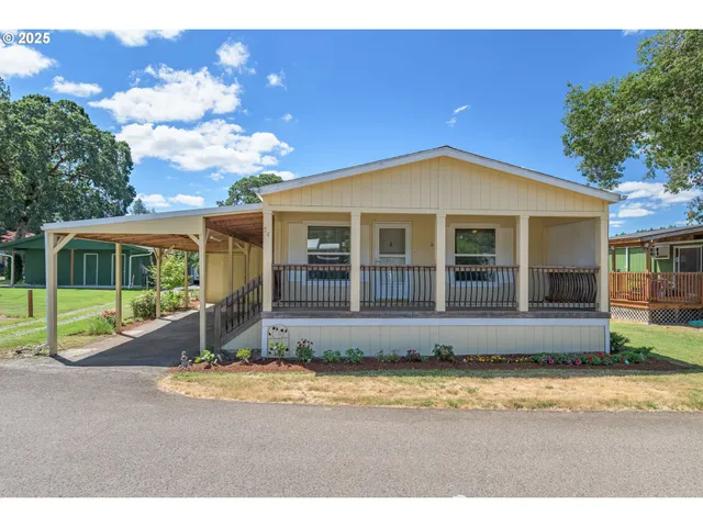a front view of a house with a yard and porch