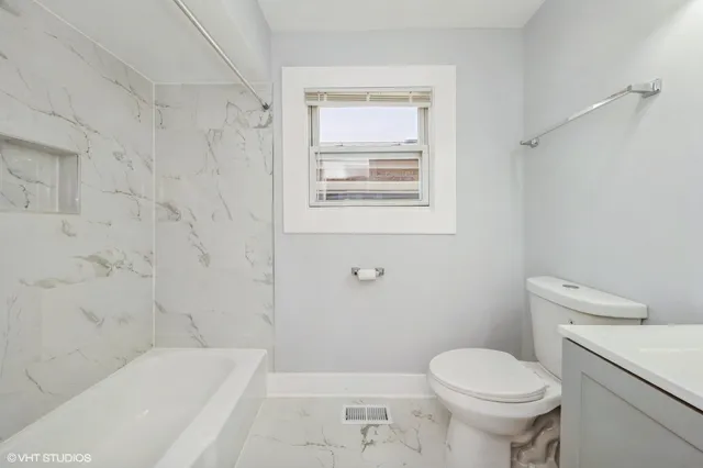 a bathroom with a toilet and a bathtub