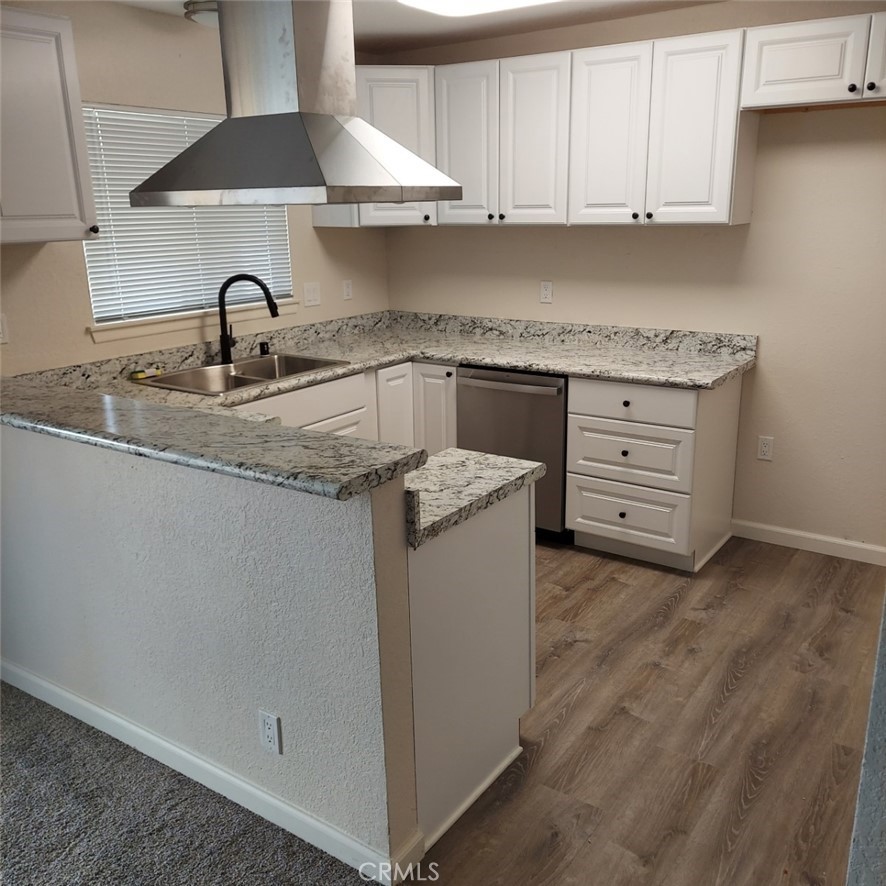 12754 Redwing Road Apple Valley, CA 92308 - Photo 2 of 9 a kitchen with granite countertop a sink and cabinets