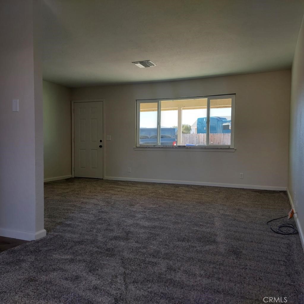 12754 Redwing Road Apple Valley, CA 92308 - Photo 4 of 9 an empty room with a empty space and windows