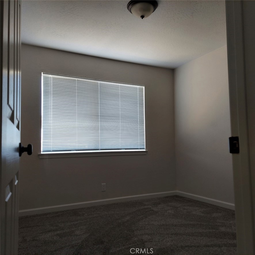 12754 Redwing Road Apple Valley, CA 92308 - Photo 6 of 9 an empty room with a window